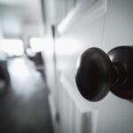 Round metal door knob on a white interior door, similar to where the ThorBolt GK1 smart knob installs
