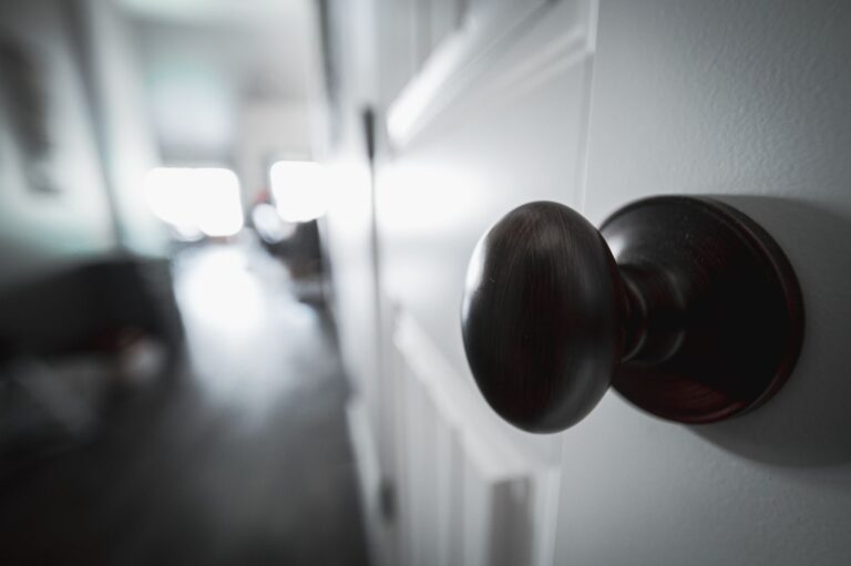 Round metal door knob on a white interior door, similar to where the ThorBolt GK1 smart knob installs