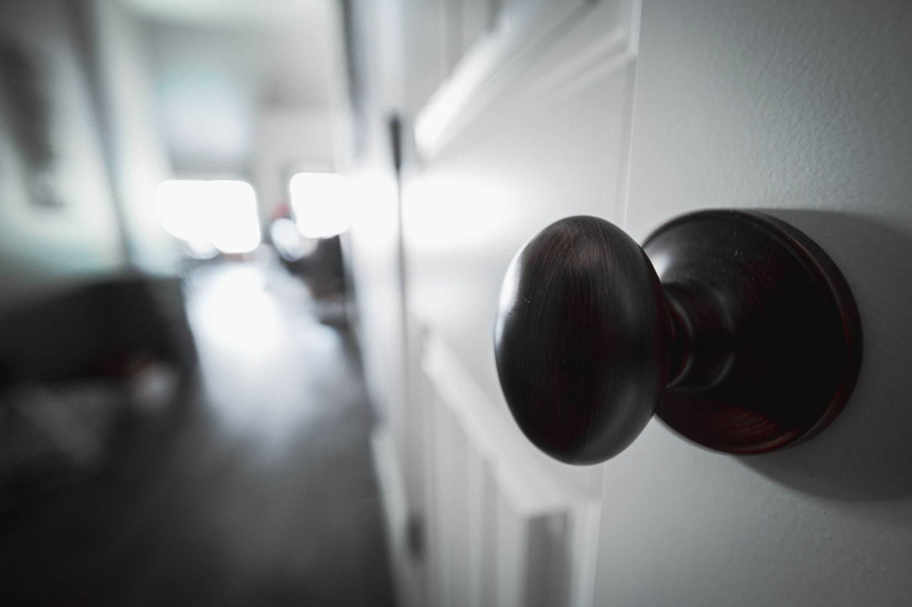 Round metal door knob on a white interior door, similar to where the ThorBolt GK1 smart knob installs