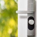 Modern smart door lock on a front door, illustrating TTLock smart lock security concerns in 2026