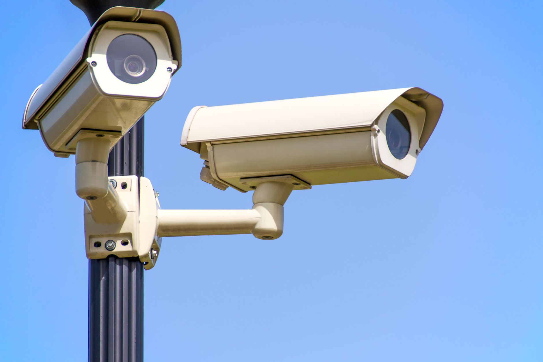 Outdoor solar security camera mounted on a house wall, similar to the Baseus X1 Pro
