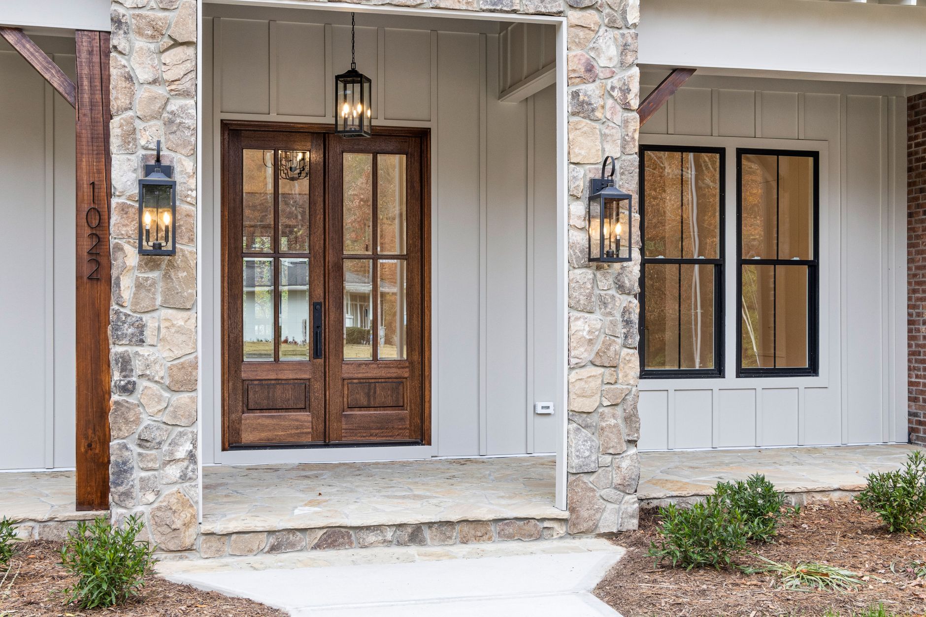 Modern front door with wooden double doors suited to a keypad deadbolt