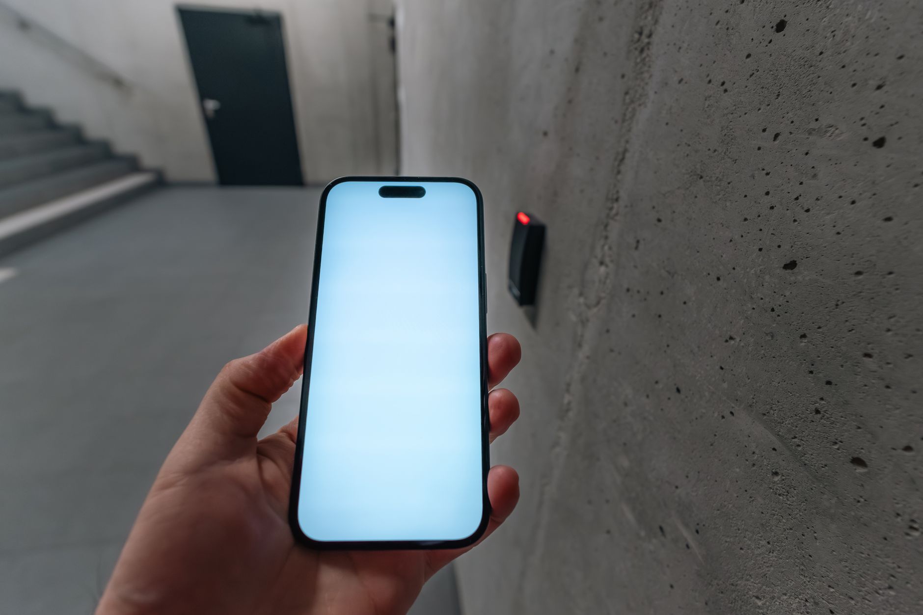 Person unlocking a smart door lock by tapping a smartphone using NFC, like the Lockly Affirm NFC unlock