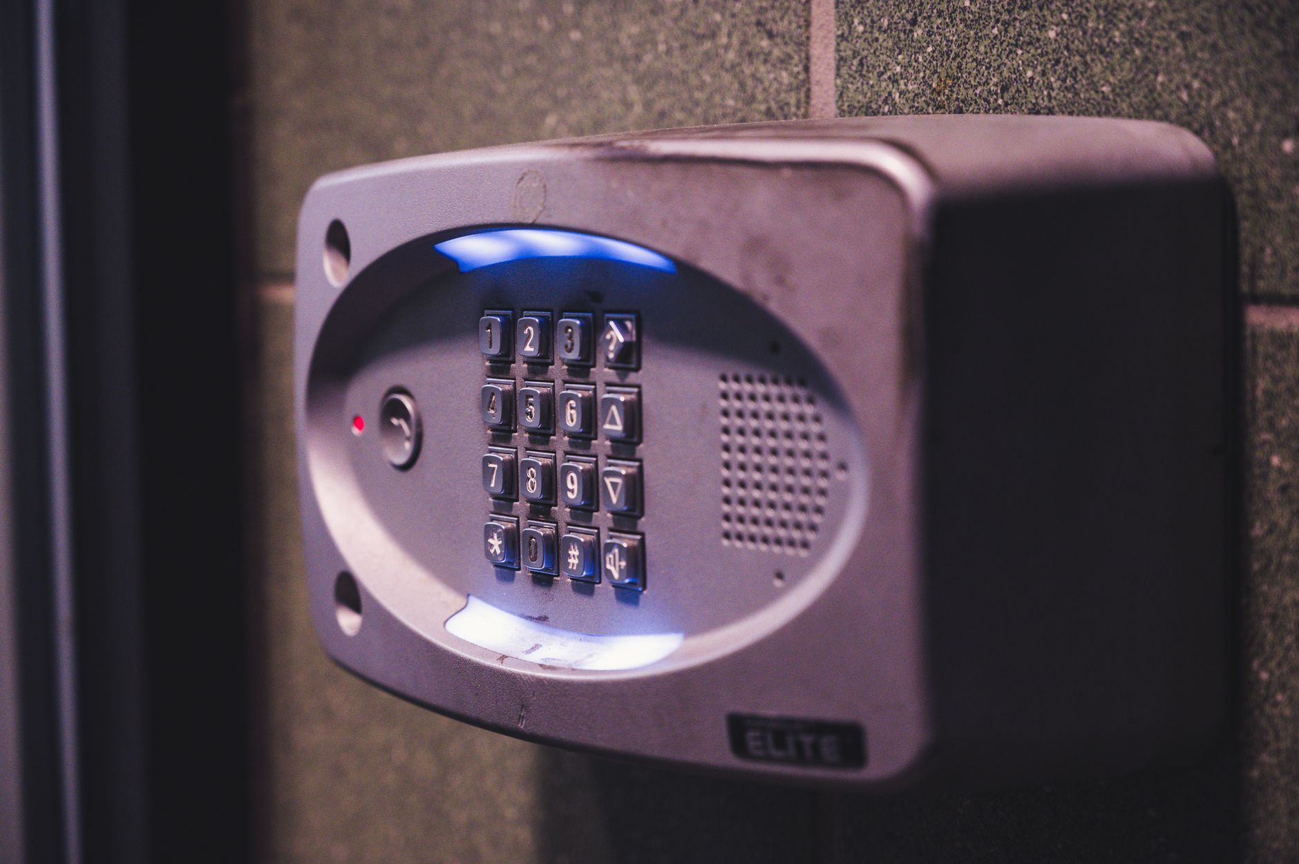 Illuminated push button keypad door lock mounted on a modern front door