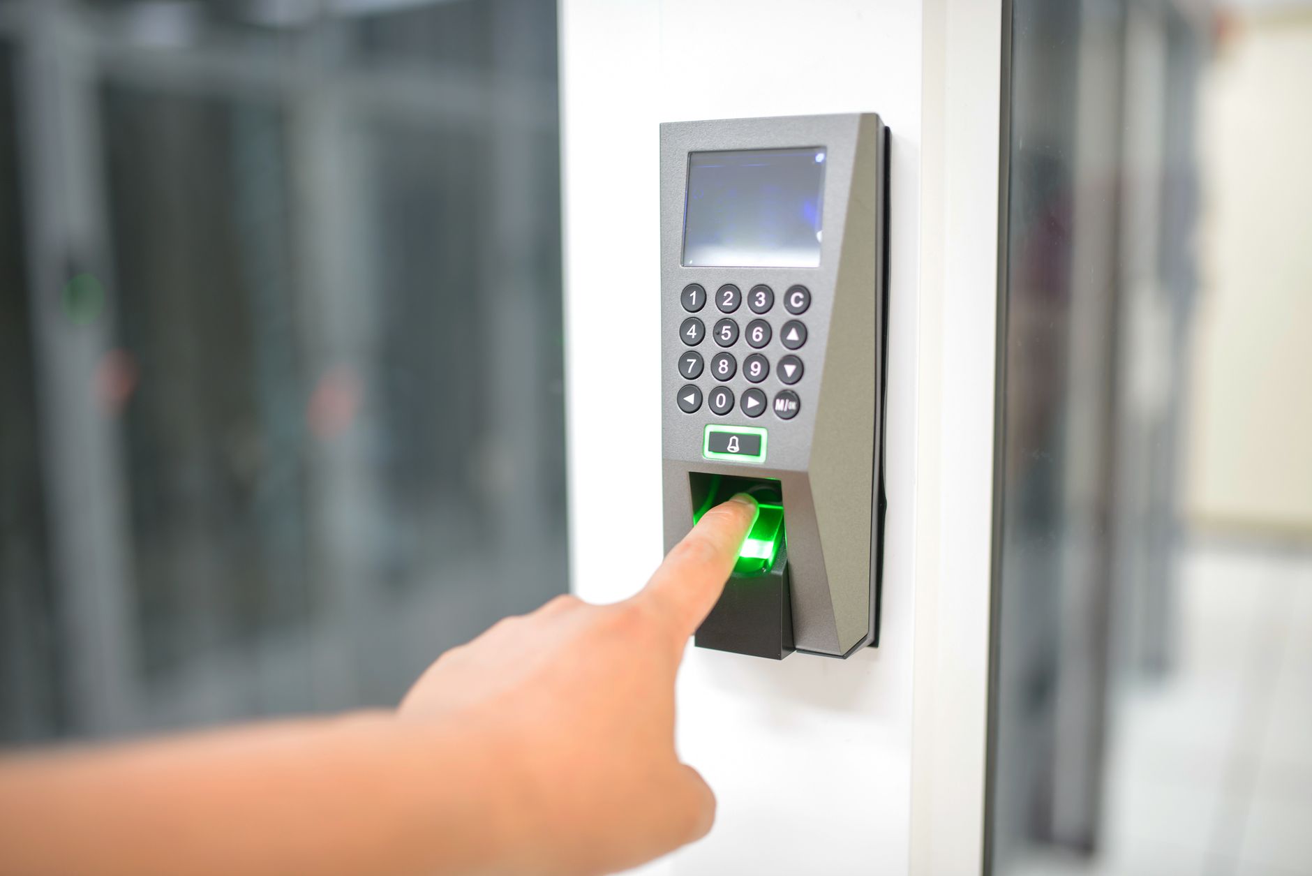 Person unlocking a door with a fingerprint scanner, similar to the Wyze Lock Bolt fingerprint reader